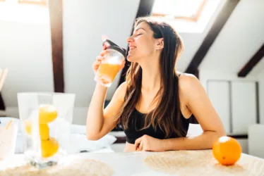 Strengthen Your Immune Response: Tips and Insights for Optimal Wellbeing 8 woman holding an orange to strengthen his immune response